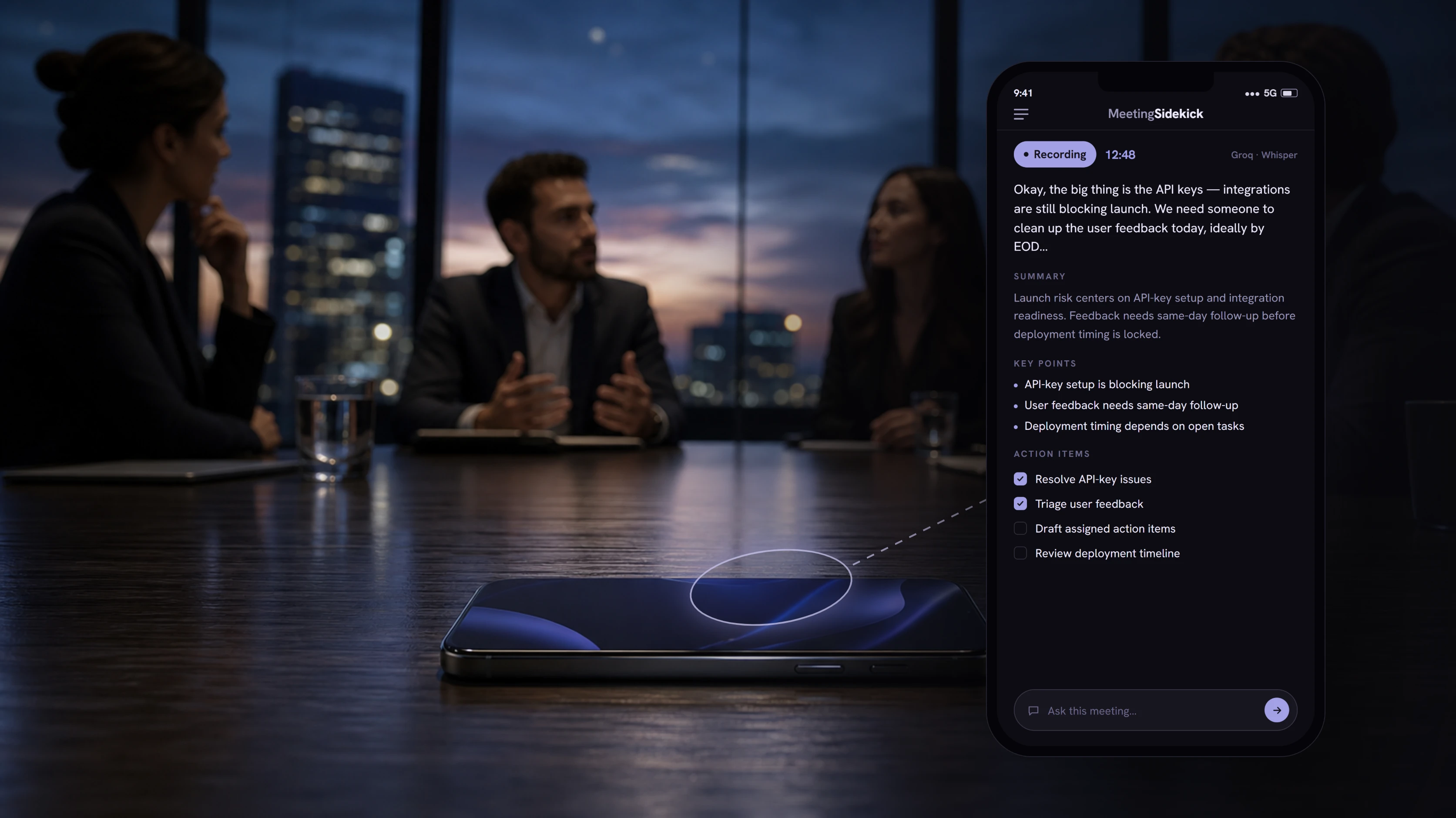 A phone on a meeting-room table running MeetingSidekick, live-transcribing an in-person conversation.